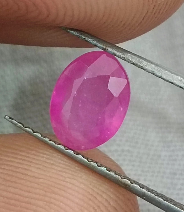Natural untreated African ruby gemstone, 1.31ct, oval cut, pinkish red color, transparent clarity, GSI certified.