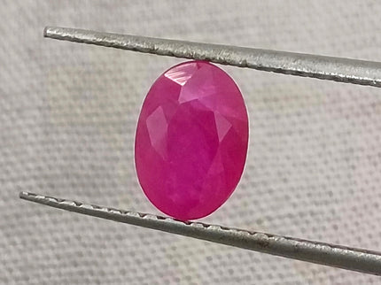 Natural untreated Mozambique ruby gemstone, semi-transparent, oval shape, red color, good cut quality.