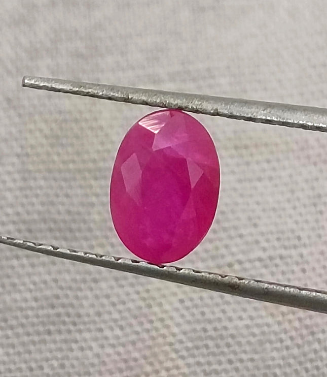 Natural untreated Mozambique ruby gemstone, semi-transparent, oval shape, red color, good cut quality.