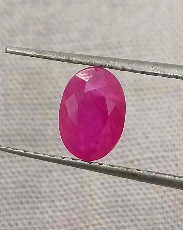 Natural untreated Mozambique ruby gemstone, semi-transparent, oval shape, red color, good cut quality.