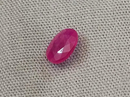 Natural untreated red ruby gemstone, oval-shaped, semi-transparent, good cut quality, measuring 6.96*4.93*2.91mm.