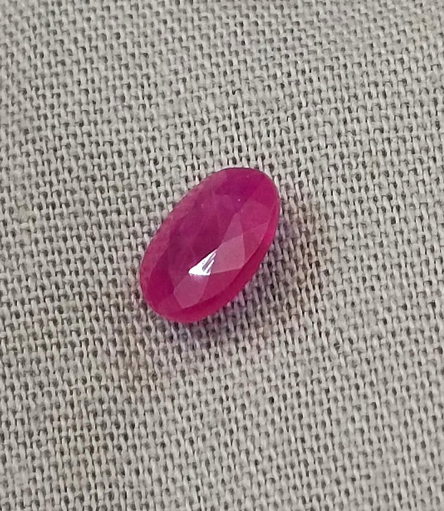 Natural untreated red ruby gemstone, oval-shaped, semi-transparent, good cut quality, measuring 6.96*4.93*2.91mm.