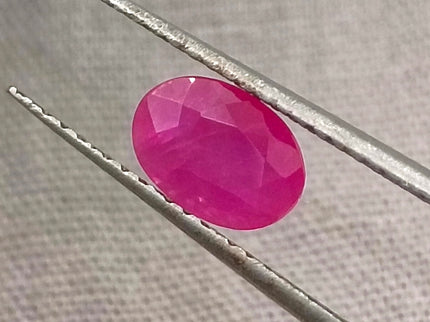Natural untreated 1.00ct African ruby gemstone, oval shape, semi-transparent, vibrant red color, good cut quality.