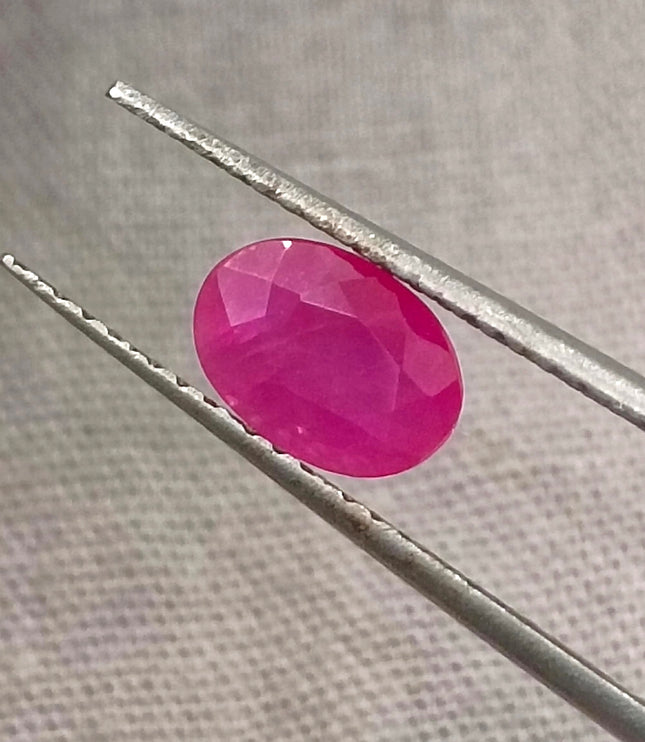 Natural untreated 1.00ct African ruby gemstone, oval shape, semi-transparent, vibrant red color, good cut quality.