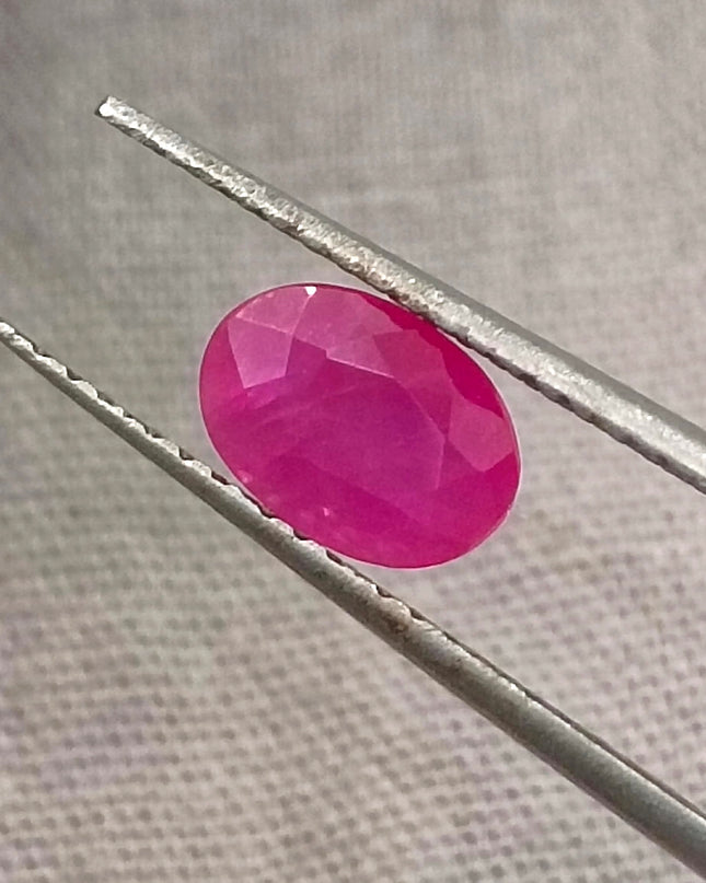 Natural untreated 1.00ct African ruby gemstone, oval shape, semi-transparent, vibrant red color, good cut quality.